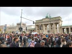 Protesters gather outside the Brandenburg Gate in Berlin